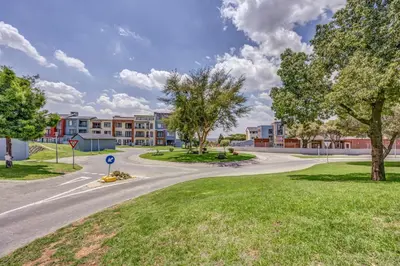 a winding road in a park with buildings at Carlswald Escape in Midrand