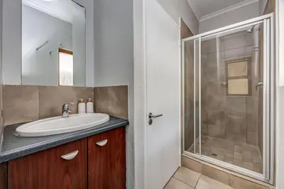 a bathroom with a sink and a shower at Carlswald Escape in Midrand
