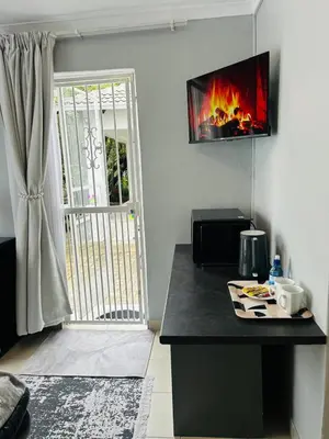 a kitchen with a counter with a fire on the wall at Rugare Haven in Kempton Park