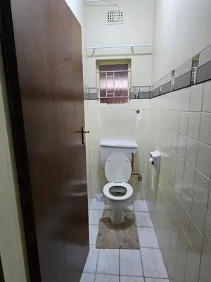 a bathroom with a toilet in a bathroom stall at The comfort in Polokwane