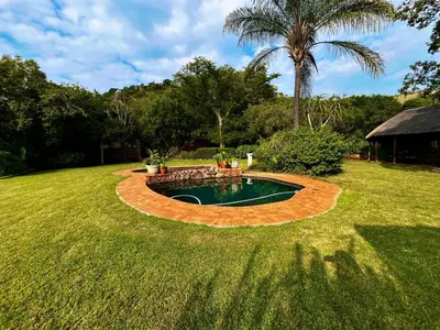 a small pool in the middle of a yard at Anahata Nature Resort in Hartbeespoort