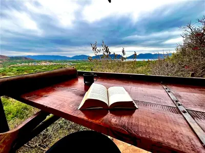 an open book sitting on a wooden table at Anahata Nature Resort in Hartbeespoort
