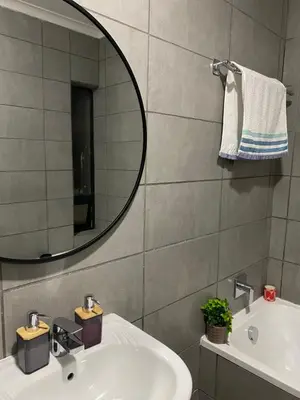 a bathroom with a sink and a mirror at Unmatched Stays in Kempton Park