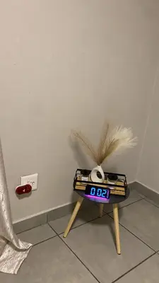 a table with a clock on it next to a wall at Unmatched Stays in Kempton Park