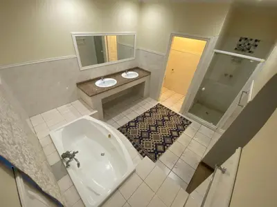 a bathroom with a tub and a toilet and a sink at Kloofyard Guesthouse in Pretoria