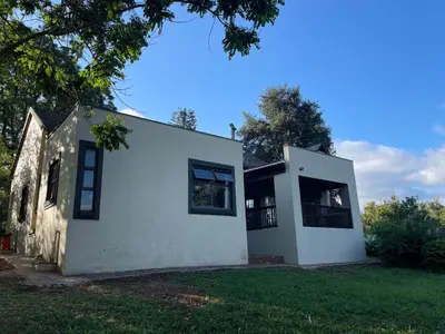 a white house with a tree at Lakeview Lodge in Hazyview