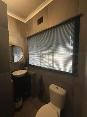 a bathroom with a toilet and a sink and a window at Warthog Wallow - Kruger National Park Phalaborwa in Phalaborwa