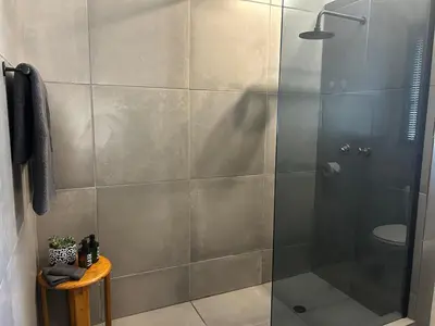 a shower with a glass door in a bathroom at Warthog Wallow - Kruger National Park Phalaborwa in Phalaborwa