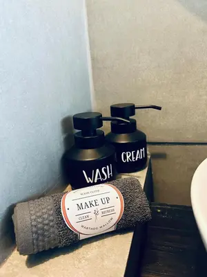 two bottles ofwash sitting on a shelf in a bathroom at Warthog Wallow - Kruger National Park Phalaborwa in Phalaborwa