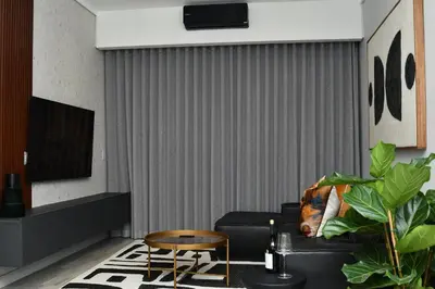 a living room with a black couch and a chair at 438 The Capital Trilogy in Pretoria