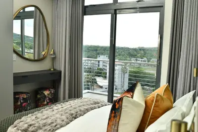 a bedroom with a bed and a large window at 438 The Capital Trilogy in Pretoria