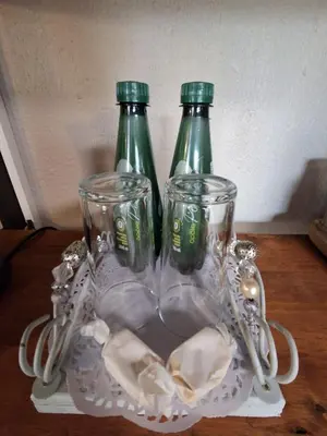 two glass bottles sitting on top of a plate at Figtree Escape in Marloth Park