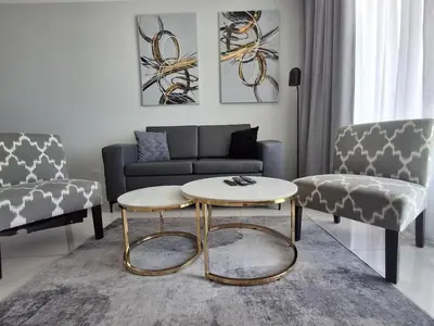 a living room with a couch and a coffee table at Ellipse 1-Bedroom Lux Apartment in Midrand