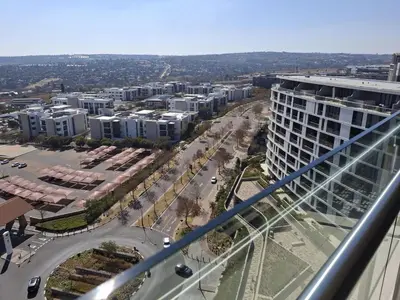 an aerial view of a city with buildings and a street at Ellipse 1-Bedroom Lux Apartment in Midrand