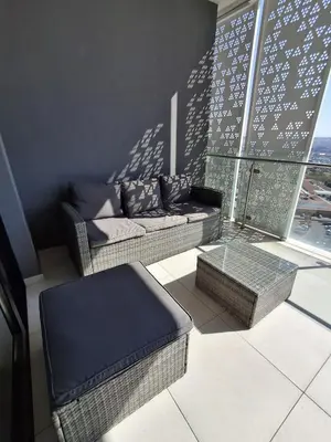 a living room with a couch and a table at Ellipse 1-Bedroom Lux Apartment in Midrand