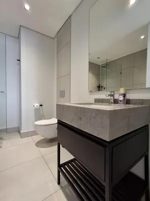 a bathroom with a sink and a toilet at Ellipse 1-Bedroom Lux Apartment in Midrand