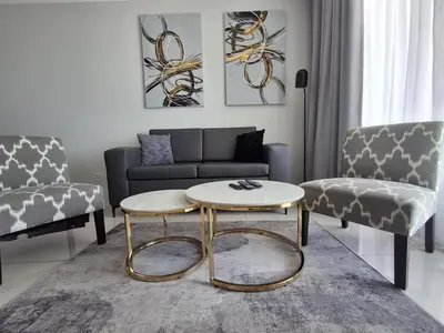 a living room with a couch and a coffee table at Ellipse 1-Bedroom Lux Apartment in Midrand