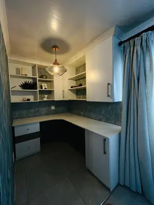 a home office with a desk and a curtain at Legae la rena in Polokwane