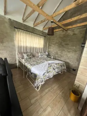 a bedroom with a bed in a room at Kiewiets Nest Guesthouse in Pretoria