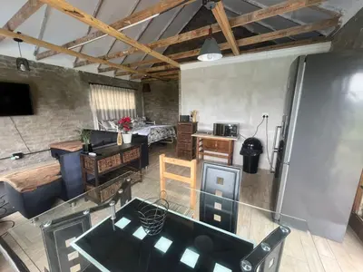 an aerial view of a kitchen and a living room at Kiewiets Nest Guesthouse in Pretoria