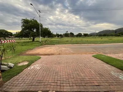 a brick road in a field with a street light at Kiewiets Nest Guesthouse in Pretoria