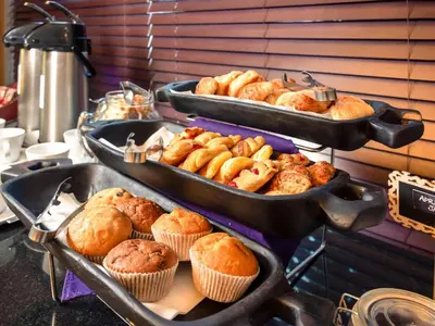 a bunch of muffins and muffins in trays at Mercure Johannesburg Midrand in Midrand