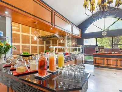 a kitchen with glasses of juice on a counter at Mercure Johannesburg Midrand in Midrand
