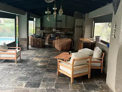 a patio with chairs and a table on a patio at BEE Boutique Lodge in Nelspruit