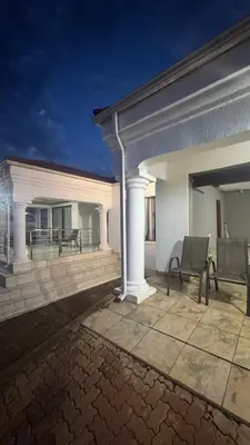 a building with a patio with a chair on a patio at Makhuvha Tshilivho Luxury House in Thohoyandou