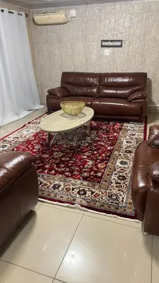 a living room with a couch and a table on a rug at Makhuvha Tshilivho Luxury House in Thohoyandou