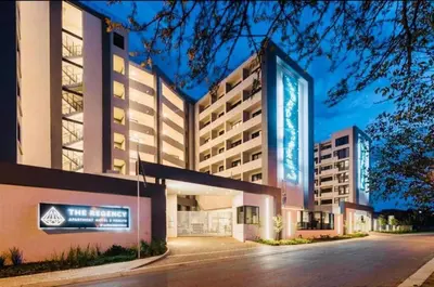 a hotel building with a sign in front of it at Regency Menlyn, 2 Bed Spacious Double Storey, New! in Pretoria
