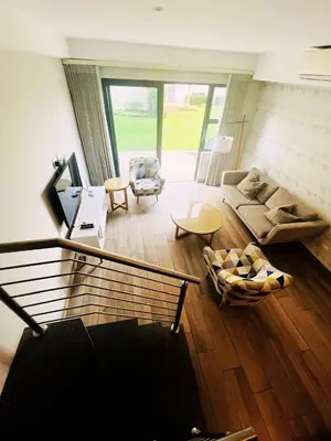 a living room with a couch and a table at Regency Menlyn, 2 Bed Spacious Double Storey, New! in Pretoria