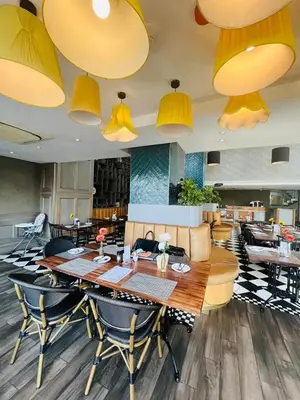 a dining room with a table and chairs and lights at Regency Menlyn, 2 Bed Spacious Double Storey, New! in Pretoria