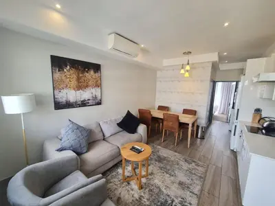 a living room with a couch and a table at Regency Menlyn Hotel 1Bed Apartment LongStay 32 percent off in Pretoria