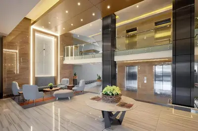 a lobby with chairs and tables in a building at Regency Menlyn Hotel 1Bed Apartment LongStay 32 percent off in Pretoria