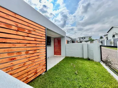 a wooden fence with a red door on a house at Midrand 2-Bedroom Oasis in Glen Austin in Midrand