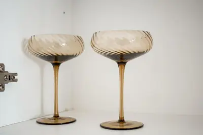 a pair of wine glasses sitting on a table at The Nest in Midrand