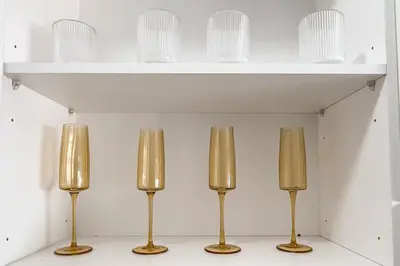 a shelf with three gold candles in a room at The Nest in Midrand