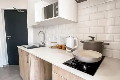 a kitchen with a sink and a counter with a toilet at The Nest in Midrand