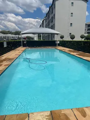 a large blue swimming pool on top of a building at Cozy getaway in Midrand