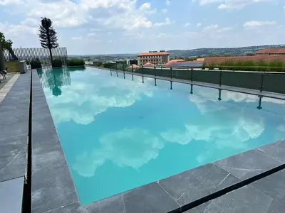 a swimming pool on the roof of a building at Entire Apartment in Midrand, South Africa in Midrand