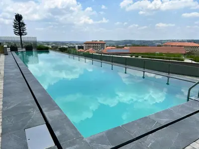 a large swimming pool on the roof of a building at Entire Apartment in Midrand, South Africa in Midrand