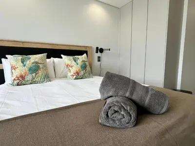 a bedroom with a bed with a pillow on it at Entire Apartment in Midrand, South Africa in Midrand