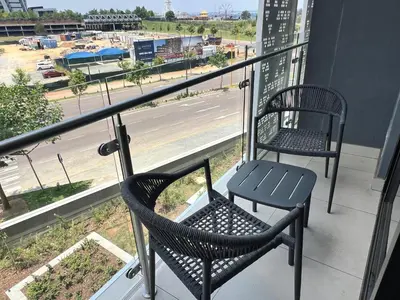 two chairs on a balcony with a view of a street at Entire Apartment in Midrand, South Africa in Midrand
