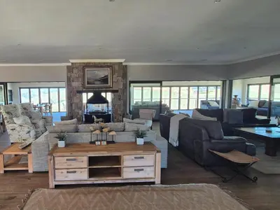 a large living room with couches and a fireplace at Highlands Retreat Lodge In Highland Gate Golf and Trout Estate 1135 in Dullstroom
