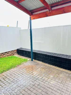 a pavilion with a white wall and a blue pole at Elusive Haven in Nelspruit