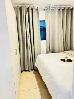 a small room with a bed and a window at Elusive Haven in Nelspruit