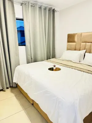 a bedroom with a bed with a tray on it at Elusive Haven in Nelspruit