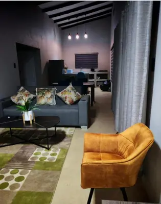 a living room with a couch and a table at Neotha Villa Unit 2 in Marloth Park