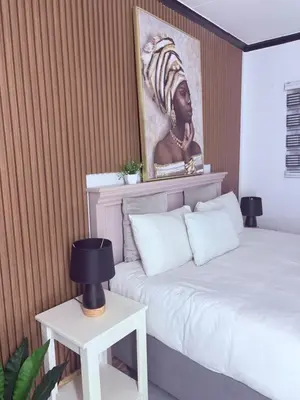 a bedroom with two beds and a painting on the wall at 43 Home Reyno ridge in Witbank